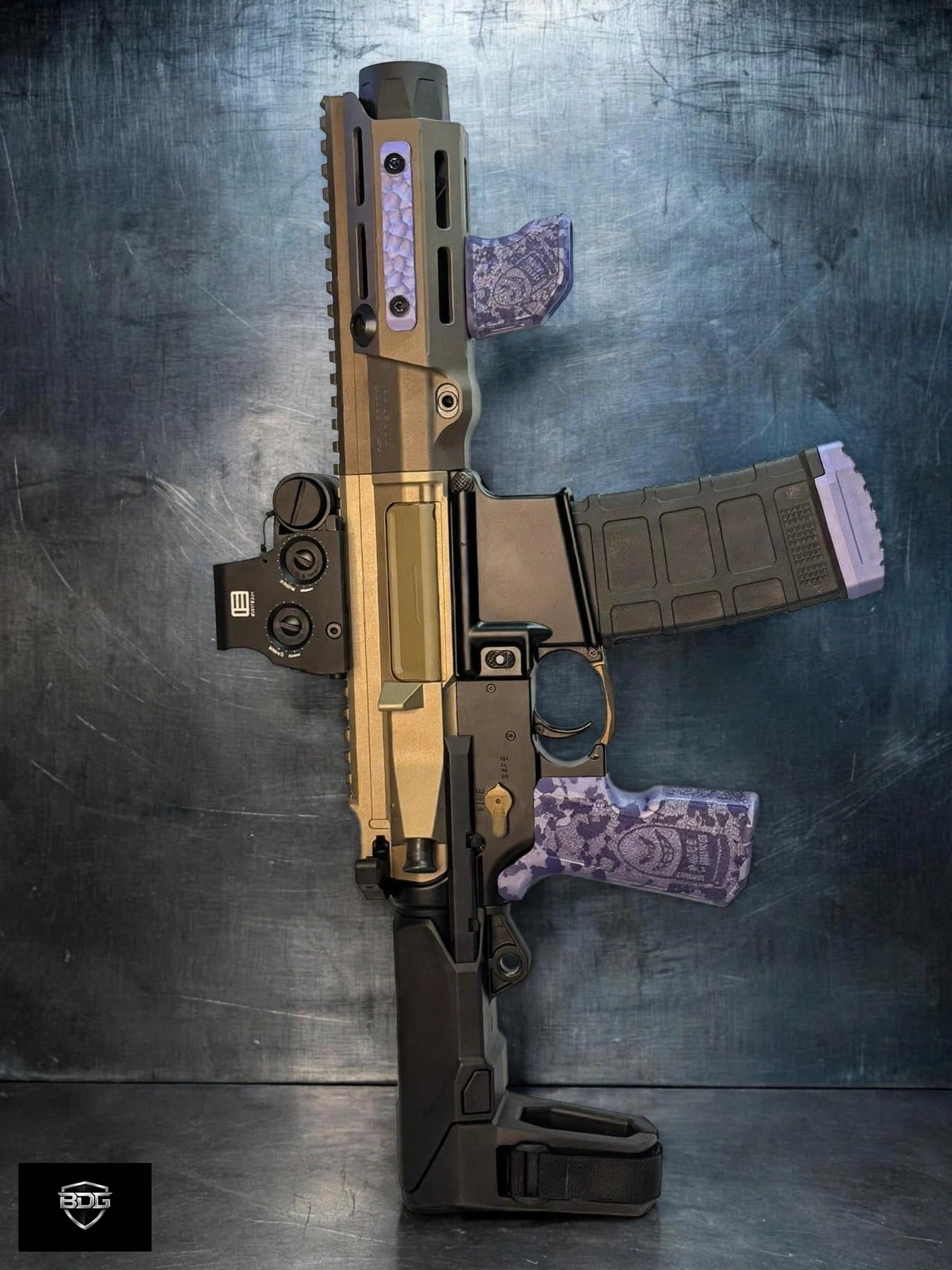 One-of-one 5.56 SOCOM PDW-pedigree AR pistol: Maxim Defense PDX upper on a Geissele Super Duty lower with EOTech XPS2-2 sight, SB Tactical HBPDW brace, and purple camo Die Free x Piece of Mind grip and Tiger Claw set — available for purchase direct from BDG